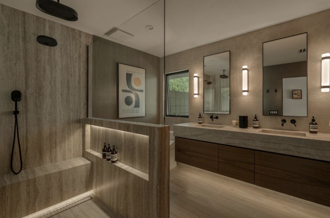 Residential bathroom inspiration with stone tile and a floating double vanity